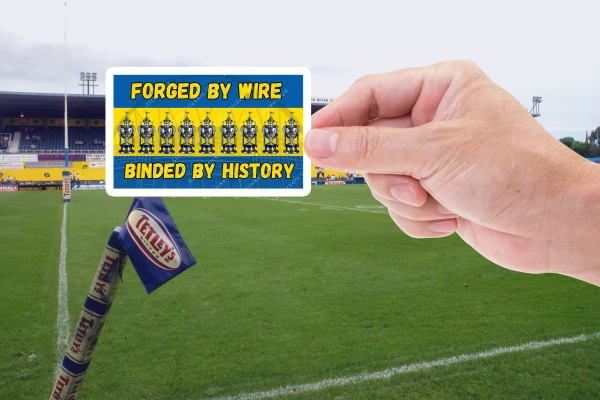 Hand holding a Forged by Wire, Binded by History sticker